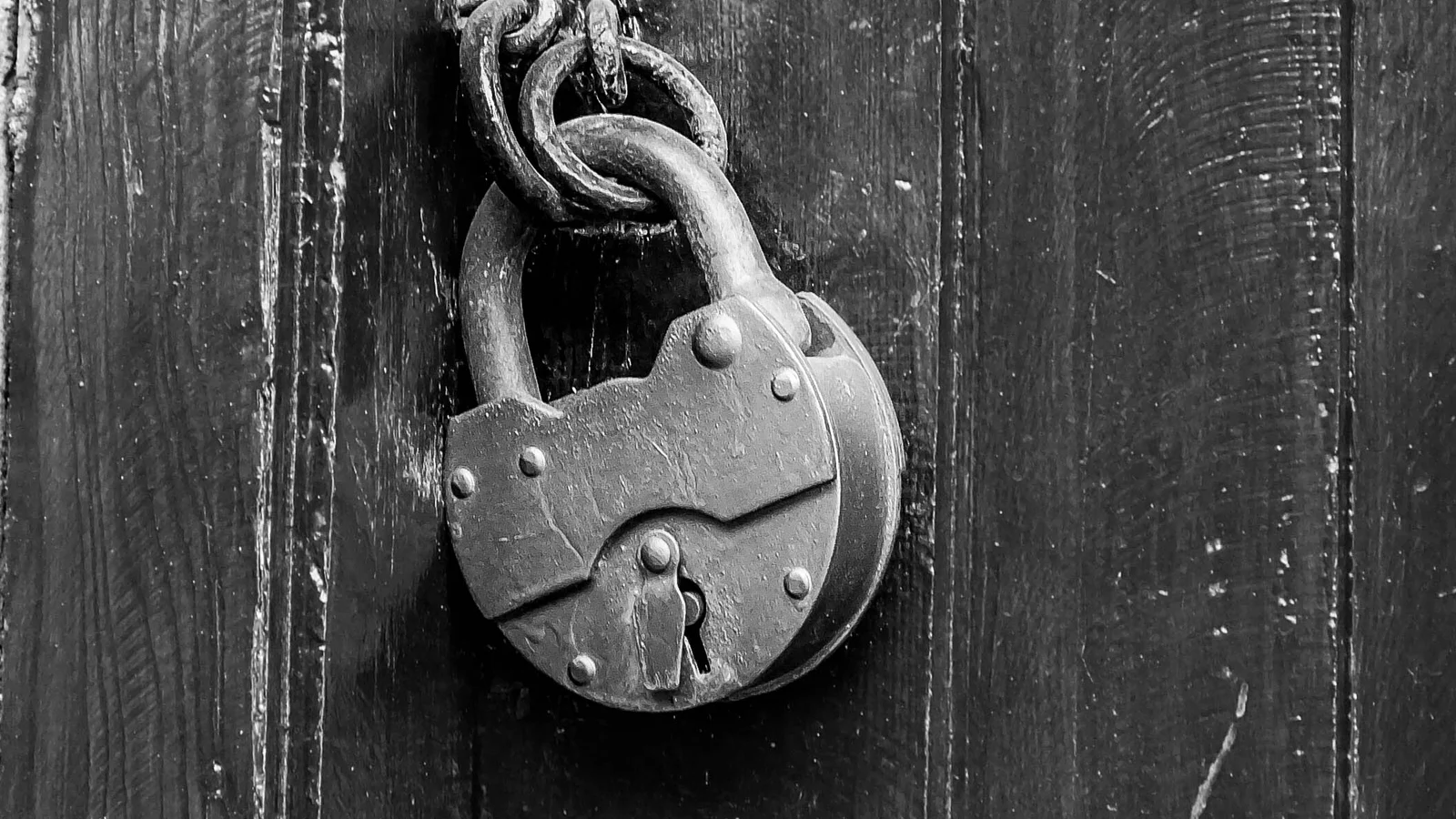 Close-up black-and-white photo of a padlock, representing access control